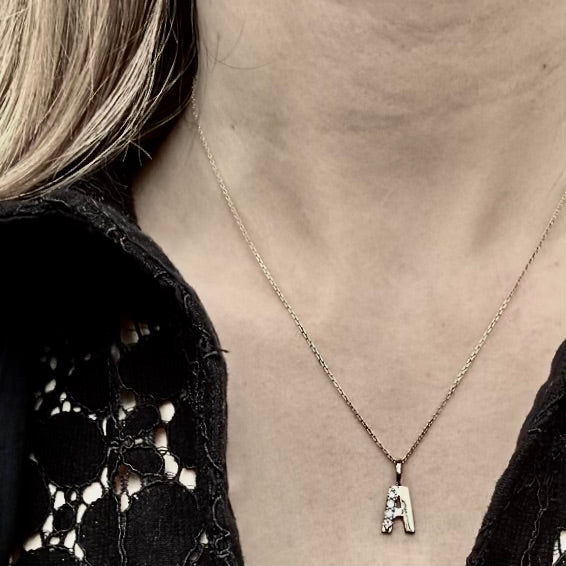 LETTERS, A Diamond Pendant 0,10ct, Gold/Diamonds